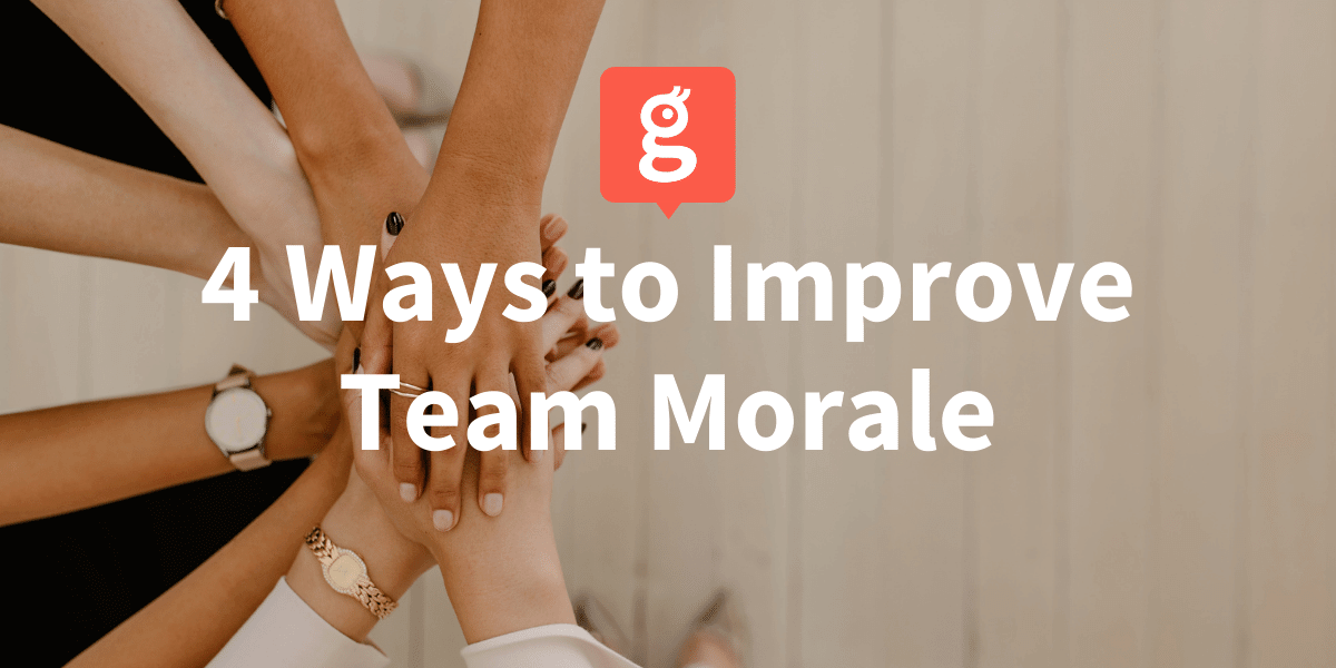 4 Ways to Improve Team Morale Office team all with hands together ready to break a huddle